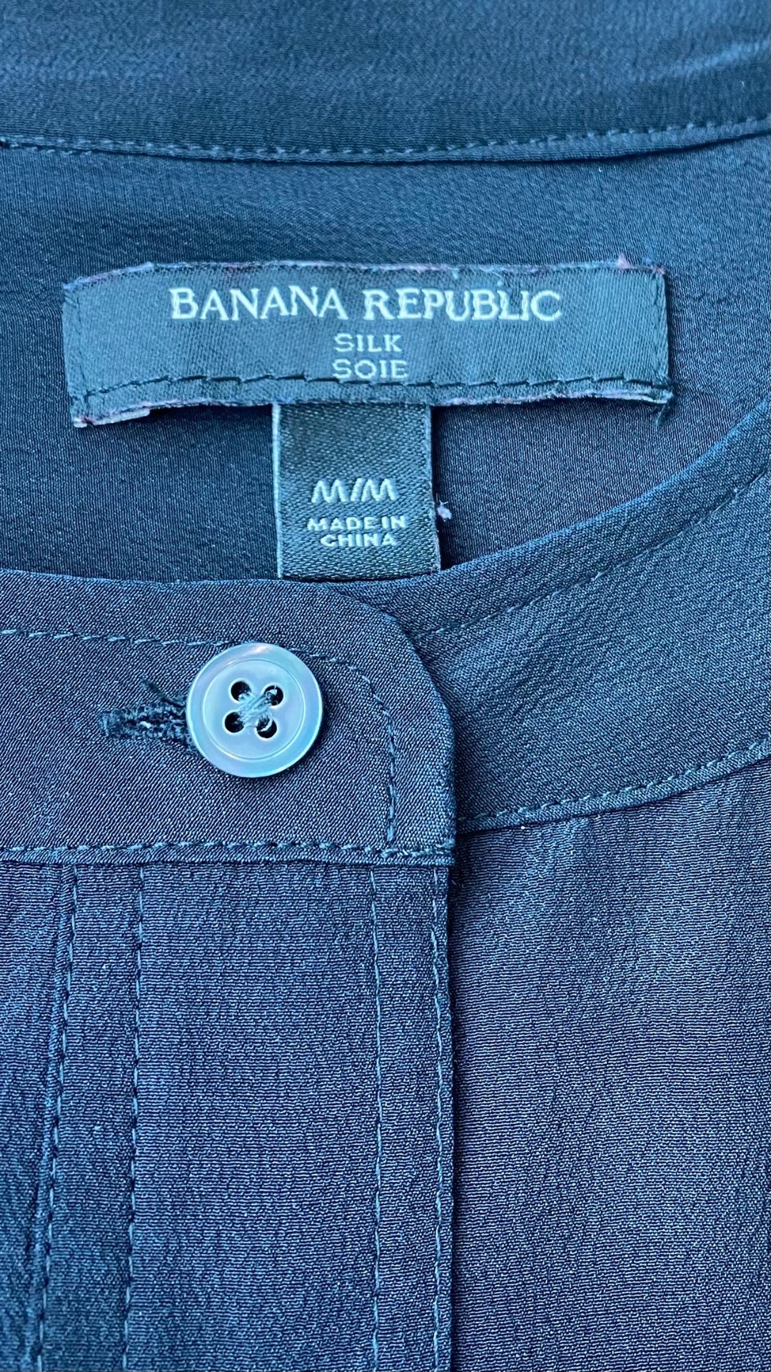 Blouse fluide en soie noire Banana Republic, taille medium. Vue de l'étiquette de marque, taille et composition.