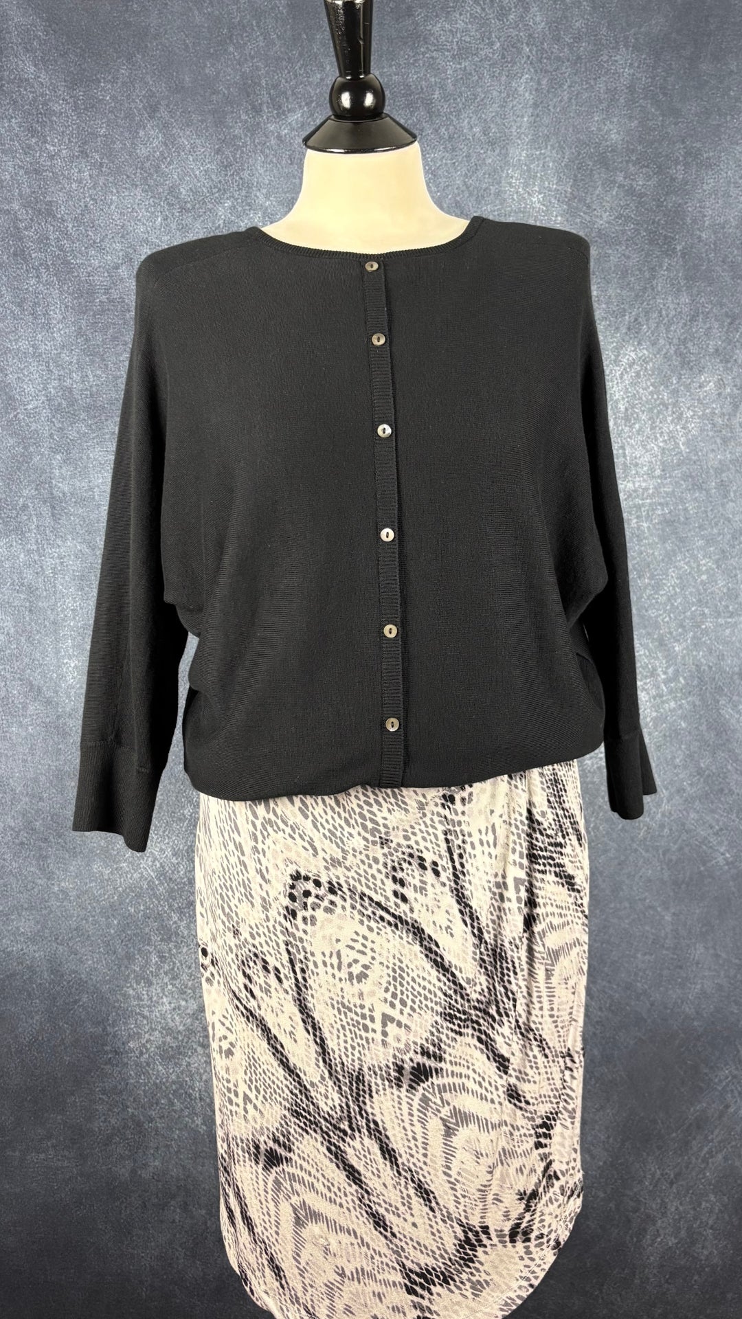 Chandail en tricot noir à col en V et dos boutonné Repeat, taille 38 (s/m). Vue de l'agencement avec la robe à motifs animaliers InWear.