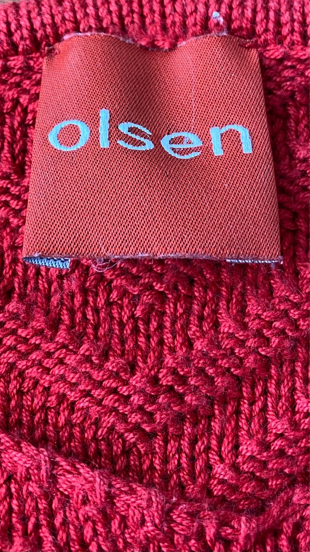 Chandail tricot rouge à chevrons Olsen, taille s-m. Vue de l'étiquette de marque.