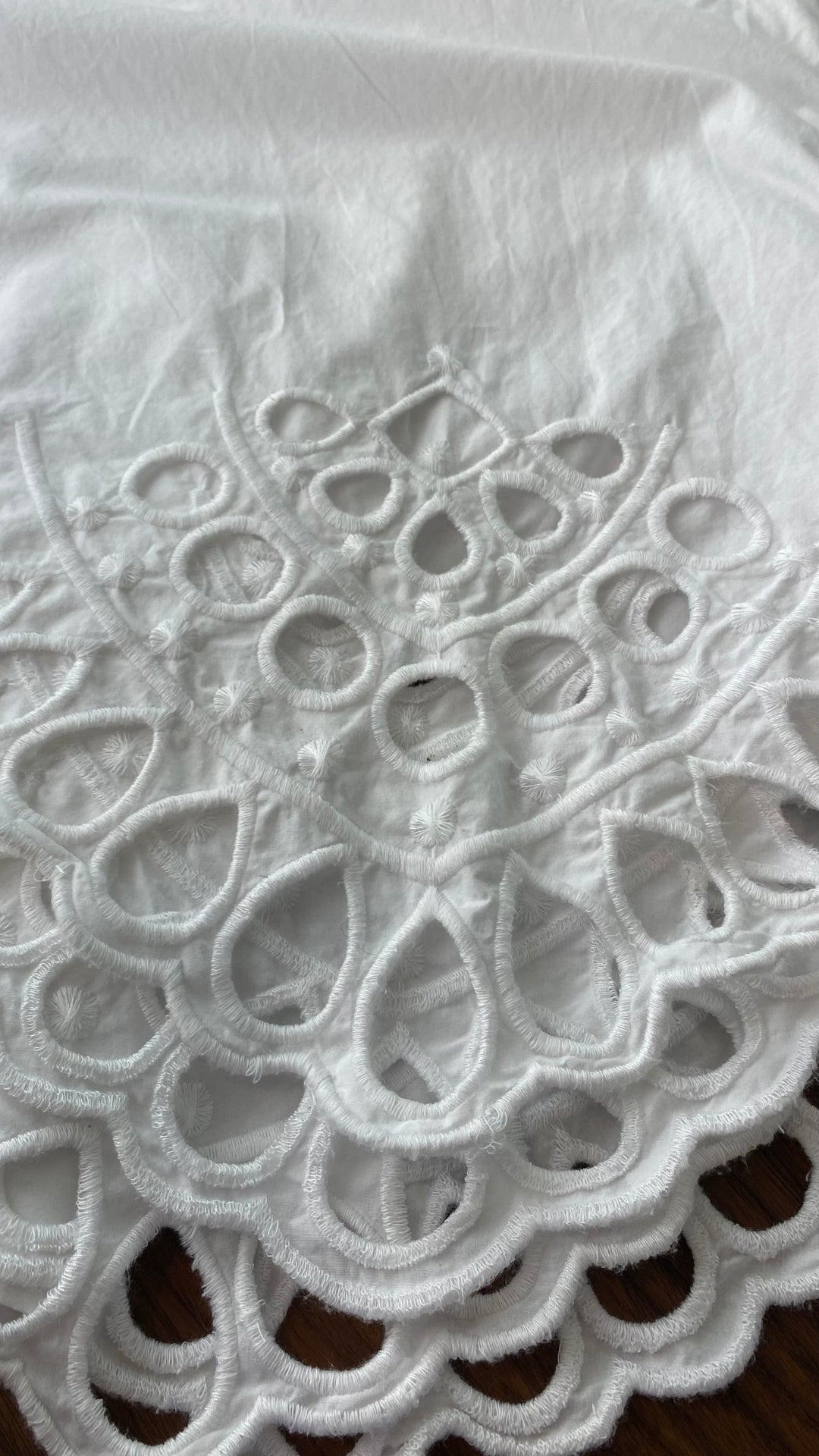 Pantalon très ample blanc style jupe avec broderie anglaise au bas des jambes. Marque French Connection, taille extra small, équivalent à 4. Vue de la broderie de près.
