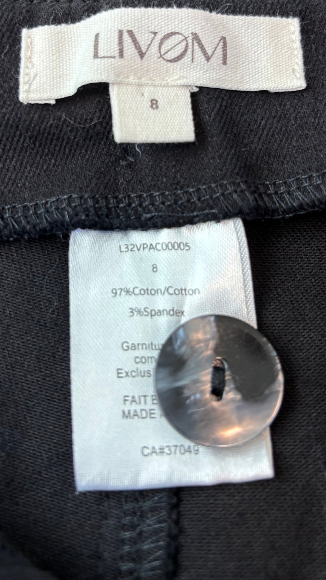 Pantalon en coton noir coupe fuselée Livom, taille 8 (s/m). Vue de l'étiquette.