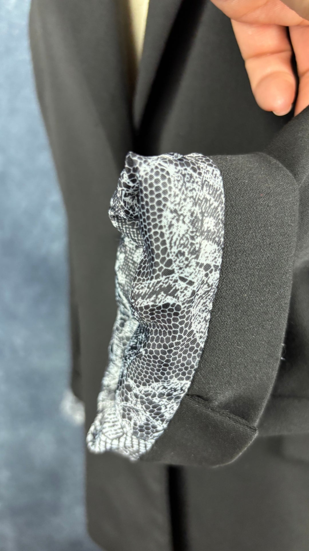 Blazer noir ajusté lavable Tristan, taille 6. Vue de près de la doublure à l'ourlet de la manche, lorsqu'elle est roulée.