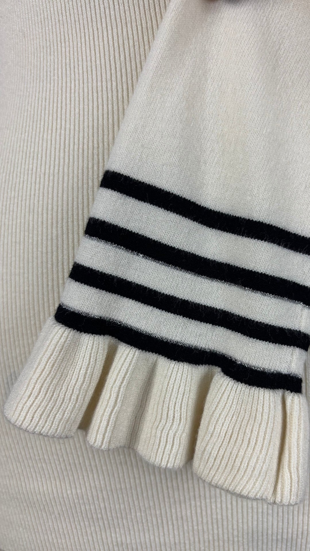 Chandail crème à col montant à ourlets à rayures noires et argentées Tristan, taille small. Vue de la manche.
