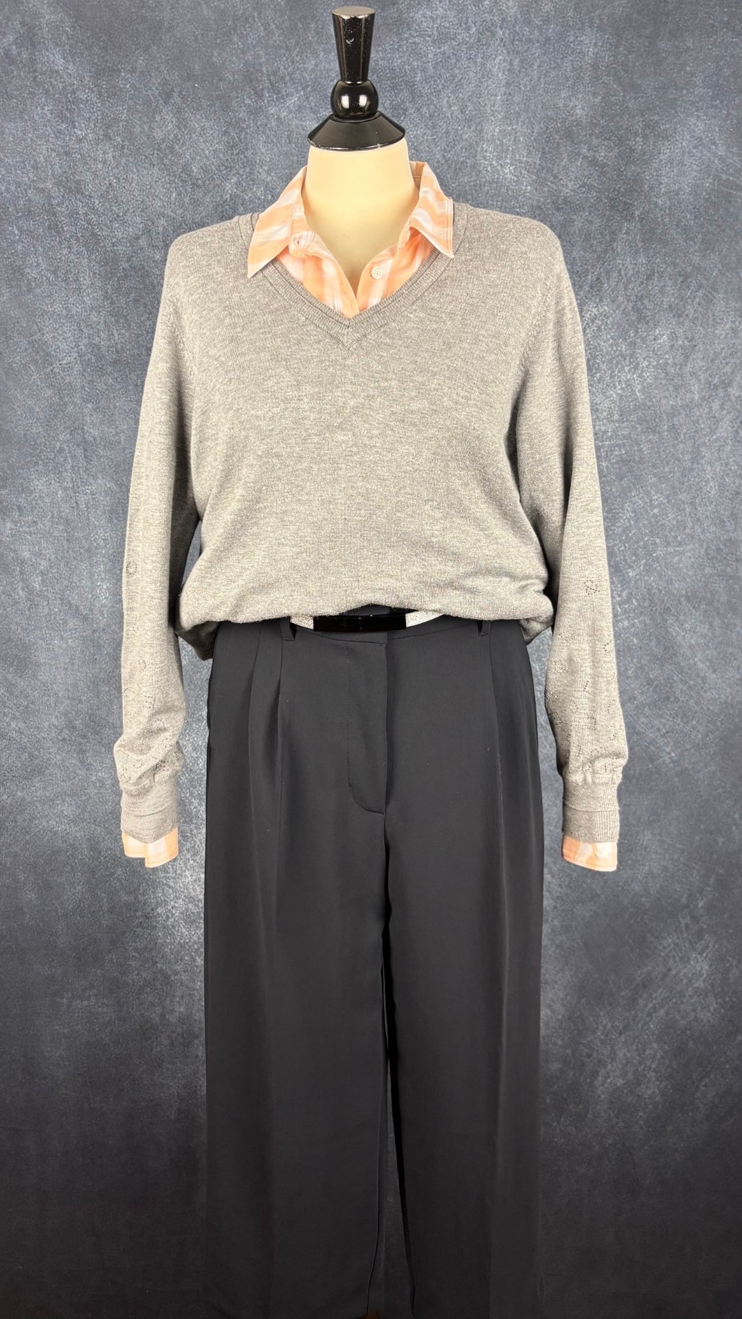 Chandail en fin tricot gris chiné avec insertions de cristaux en forme de lettres de l'alphabet au bas des manches Leo & Ugo, taille 4 (large). Vue de l'agencement avec la ceinture argent one size, le pantalon marine Effortless et le chemisier à carreaux corail Banana Republic.