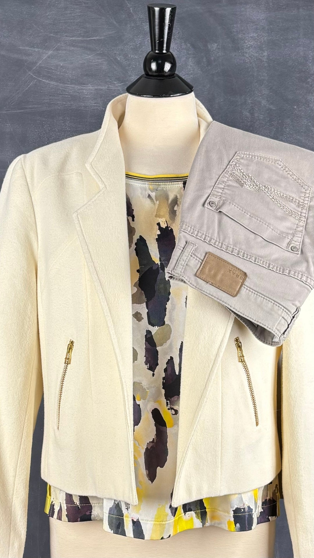 Chandail à motif abstrait jaune Jean Paul Berlin, taille 6. Vue de l'agencement avec la veste crème style perfecto et le pantalon taupe Brax.