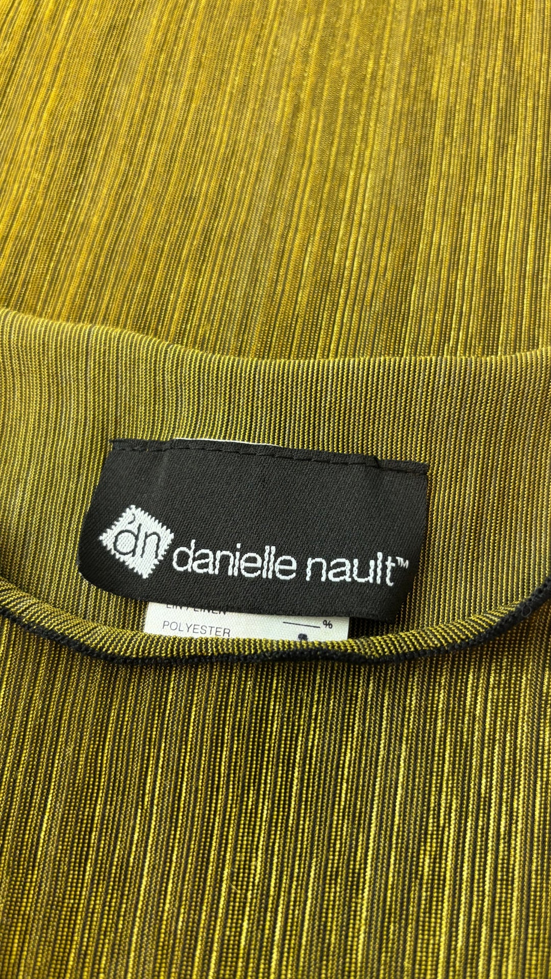 Chandail plissé chartreuse dorée liséré noir Danielle Nault, taille medium. Vue de l'étiquette.