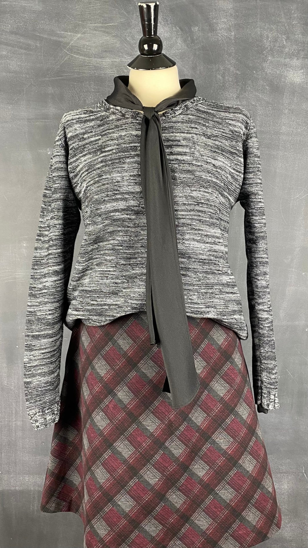 Chandail tricot col rond chiné Minimum, taille large. Vue de l'agencement avec une blouse à col lavallière et une jupe à carreaux.
