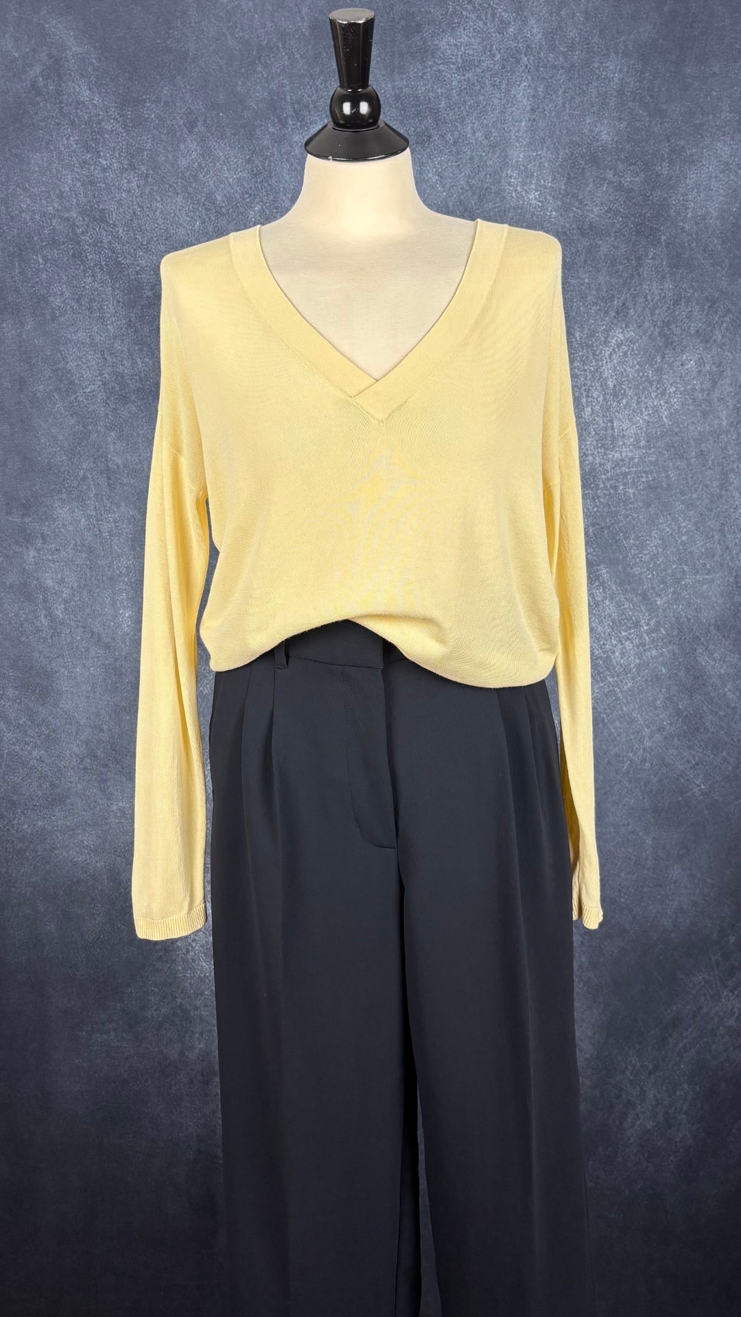 Chandail en tricot fin jaune doux à col en V large Samsøe Samsøe, taille estimée à small. Vue de l'agencement avec le pantalon Effortless Pant marine très foncé.