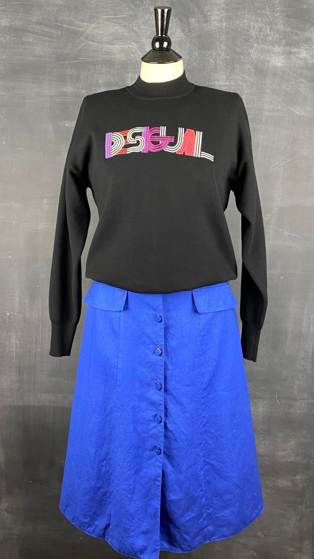 Chandail en tricot léger noir avec broderie Desigual, taille small. Vue de l'agencement avec la robe en lin bleu.