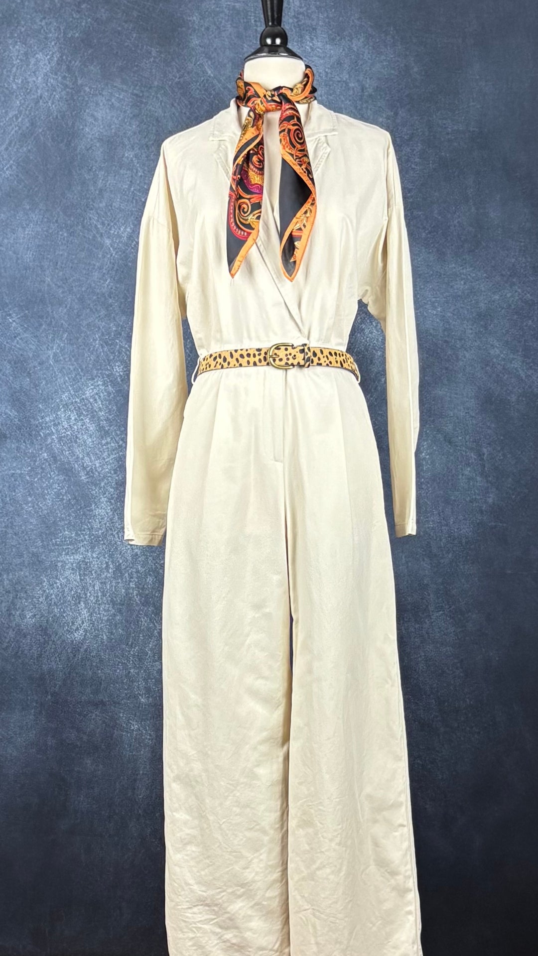 Combinaison beige doux à jambe large et taille soulignée en coton et Tencel, La Petite Étoile Paris, taille 2 (s/m). Vue de l'agencement avec la ceinture à motifs animaliers et le foulard soyeux coloré.