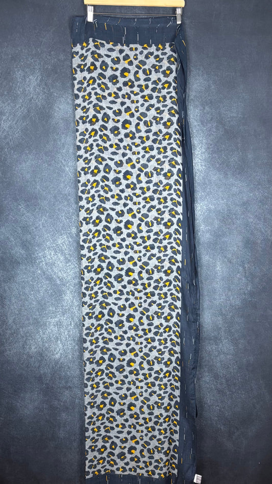 Foulard à motif animalier marine, bleu-gris et jaune ocre Sandwich, taille grand rectangle. Vue de face du foulard plié en deux sur un cintre.