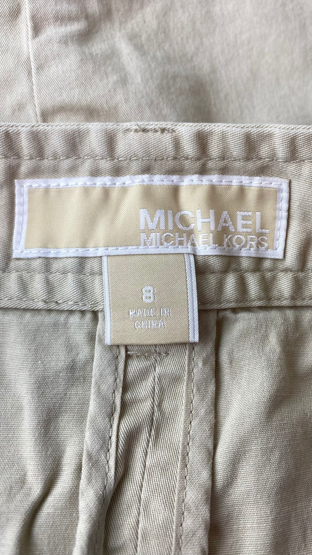 Jupe sable à boutons et détails dorés Michael Kors, taille 8. Vue de l'étiquette de marque et taille.