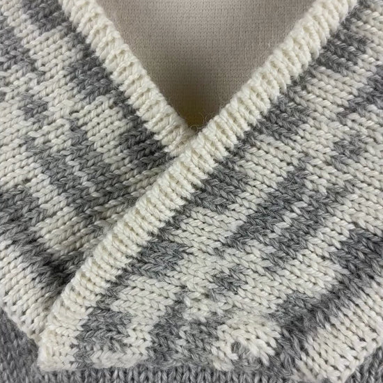 Chandail norvégien gris et crème en laine vierge et col en V, Dale of Norway, taille large. Vue de la vidéo qui présente tous les détails du chandail.