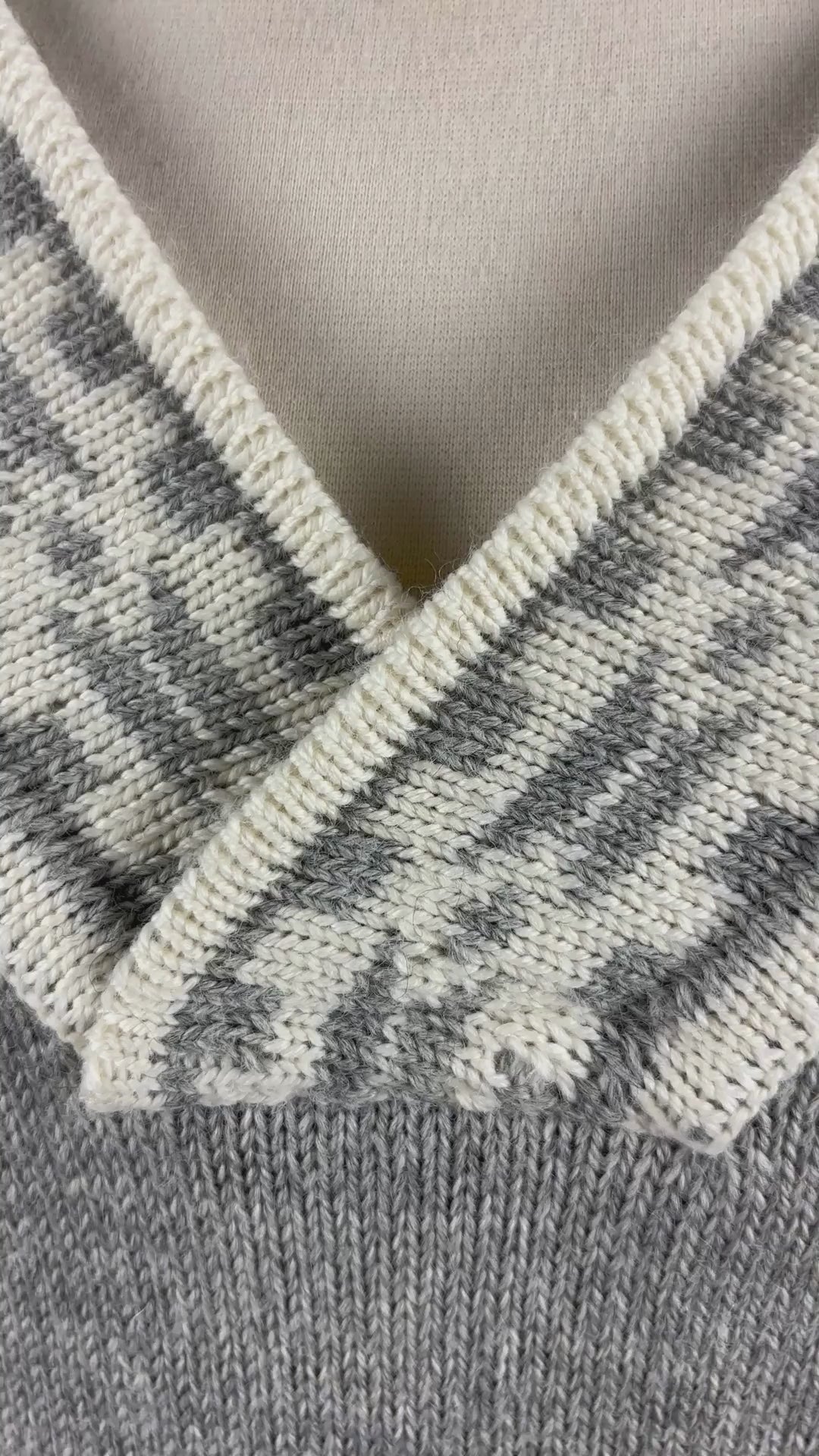 Chandail norvégien gris et crème en laine vierge et col en V, Dale of Norway, taille large. Vue de la vidéo qui présente tous les détails du chandail.