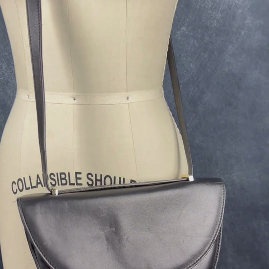 Sac en cuir lisse en demi-lune avec courroie type bandoulière, Flattered. Vue de la vidéo qui présente tous les détails du sac.