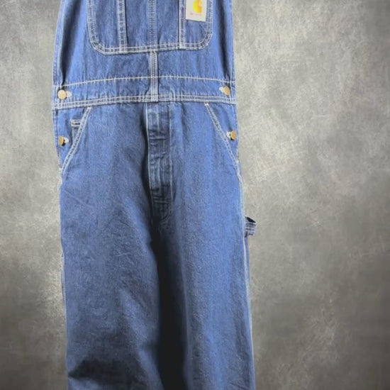 Salopette en jeans foncé Carhartt, taille 32. Vue de la vidéo qui présente tous les détails de la salopette.