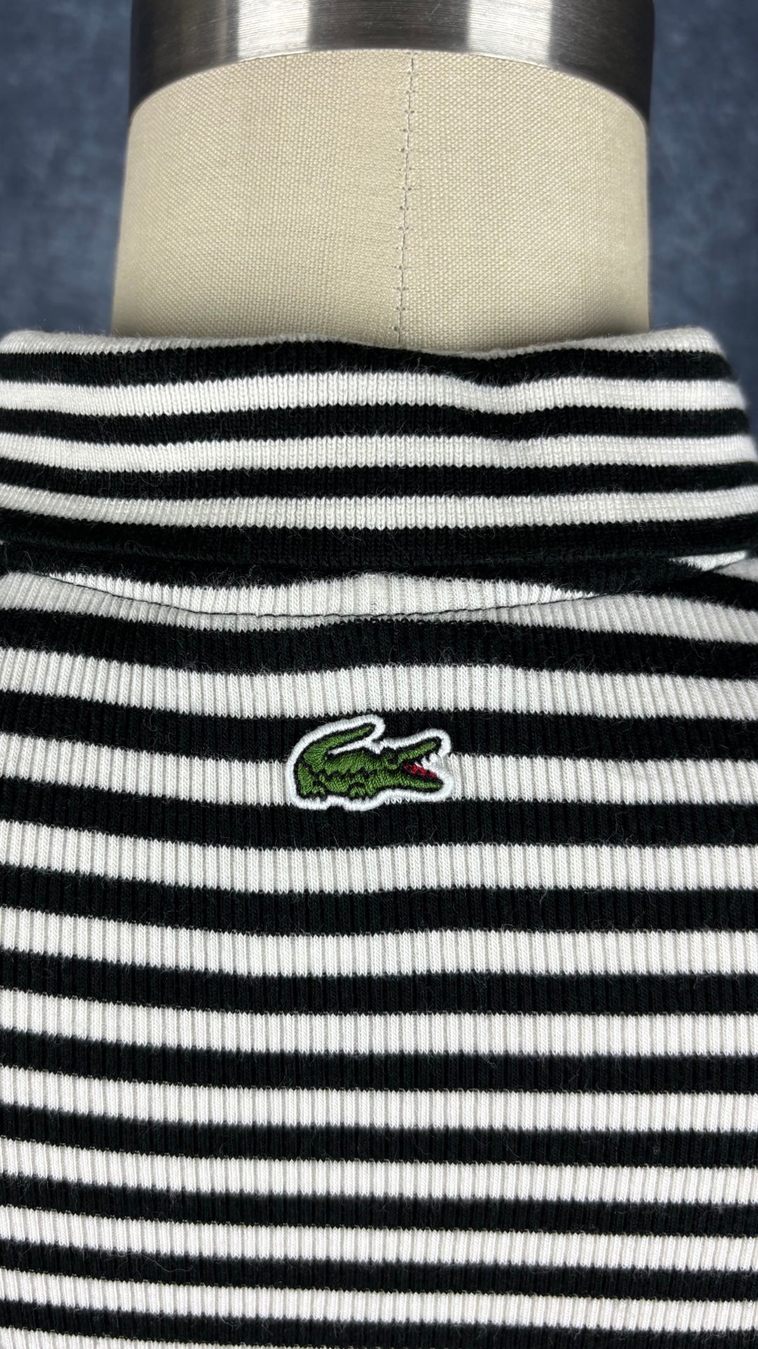 Robe polo à rayures noires et crème Lacoste Live, taille small. Vue de près du logo central au haut du dos (crocodile).