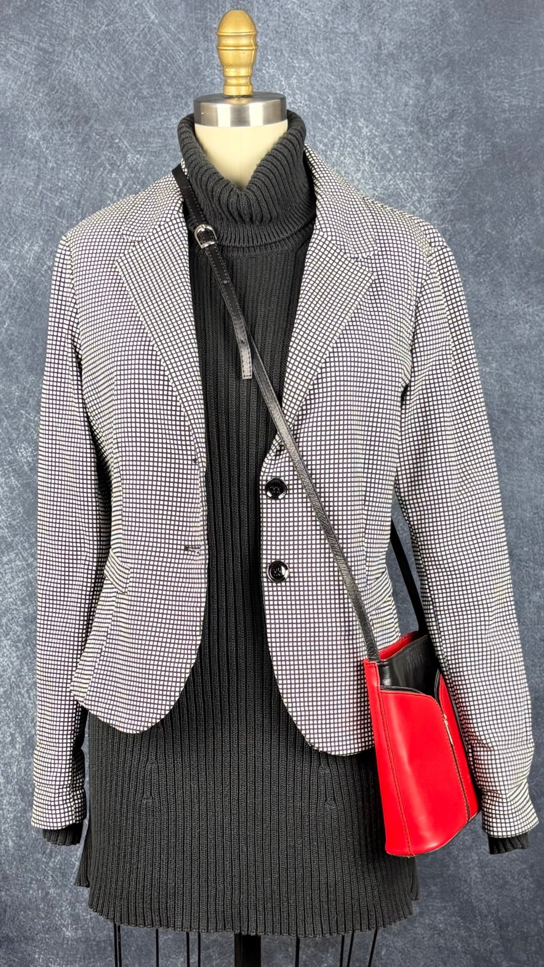 Robe tunique noire en tricot à col roulé Marc Cain, taille estimée à xs/s. Vue de l'agencement avec le blazer Imperial à petits carreaux et le sac à main en cuir noir et rouge Vera Pelle.