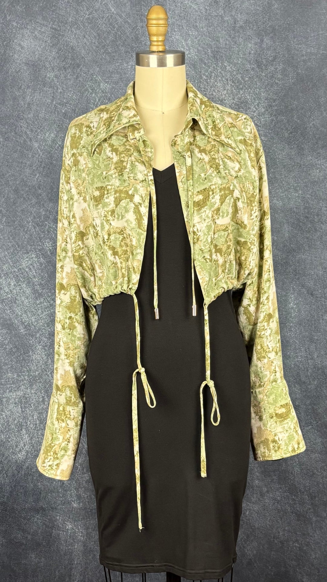 Veste courte à col chemisier à motifs abstraits Joelle, taille small. Vue de l'agencement avec la robe noire à col V Joelle.